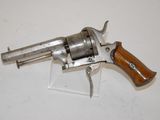an old revolver with a wooden handle on a white surface