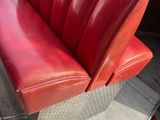 a red bench that is sitting on top of a table