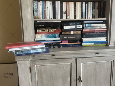 a book shelf with many books on top of it