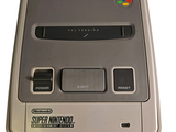 an old nintendo game console with a rainbow sticker on it