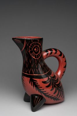 an image of a red and black vase on a gray background