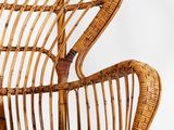 a wicker chair that is sitting on a white surface