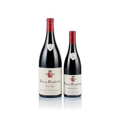 two bottles of red wine sitting next to each other on a white surface