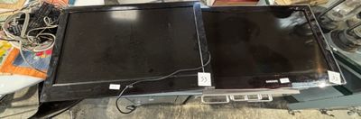 two laptops sitting on top of each other on a table