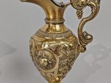 a gold vase that is sitting on a table