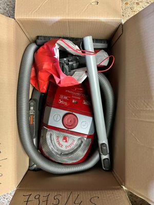a box with a vacuum and other items inside of it