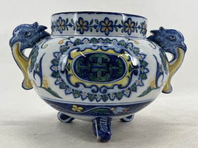 a blue and white vase with two lions on it