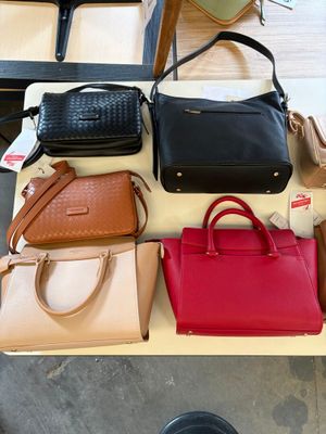 a lot of purses that are on a table