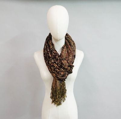 a mannequin with a scarf on it in front of a wall