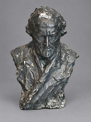 un buste en bronze représentant un homme à la longue barbe