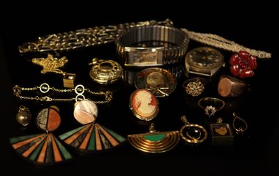 many different types of jewelry on a black surface