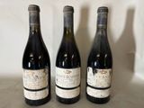 three bottles of wine are lined up on a counter top