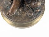 bronze statue of a dog and a cat on a round base
