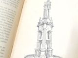 un livre ouvert sur lequel est dessiné un clocher