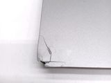 a broken laptop computer sitting on a white surface