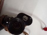 a small camera attached to a wall with a cord around it