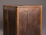 an old wooden chest with a door and a drawer on top of it