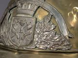 a gold helmet with a coat of arms and a crest on it