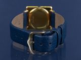 a watch that is sitting on top of a blue table