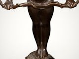 bronze statue of a boy holding a snake on a marble base