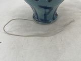a small blue bowl with a white ball in it