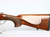 a close up of a rifle on display on a white surface