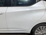 a small white car parked on the side of the street