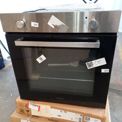 an image of a stainless steel oven sitting on top of a stack of boxes