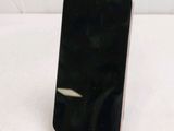 a black cell phone sitting on a stand on a white surface
