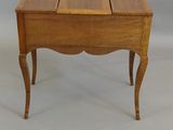 a small wooden table with a drawer on it