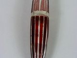 une image représentant une brosse à dents rouge et blanche posée sur une surface blanche