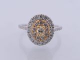 a white and yellow gold diamond ring with a flower design