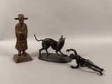 a statue of a dog and a statue of a man with a dog