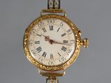 a gold wrist watch with roman numerals on the face