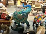 many figurines of elephants on display in a shop