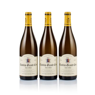 three bottles of wine sitting next to each other on a white surface