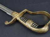 a close up of a sword on a table with a black background