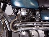 a blue motorcycle parked in a garage with a white wall in the background