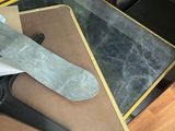 a pair of scissors sitting on top of a cutting board