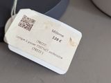 a tag that is attached to a lamp that is on a table