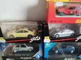 four toy cars that are sitting in a box