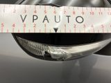 a picture of a close up of a measuring tape on a car ' s headlight