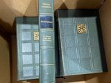 two books stacked on top of each other in a box