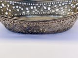 a metal bowl with a decorative design on it