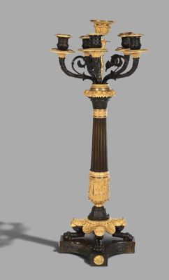 an image of a black and gold candelab with four candles