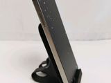 a cell phone that is on a stand on the table