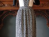 black and white dress on a mannequin mannequin stand in front of a fireplace