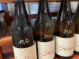 four bottles of wine are lined up on a table