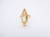 a gold ring with a faceted citrine stone in the center