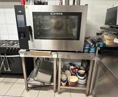a microwave that is sitting on a stand in a kitchen